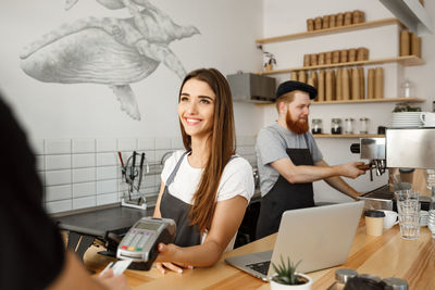 Man and woman working in cafe