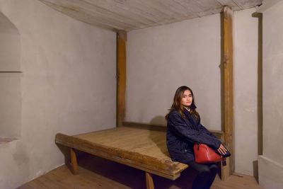 Portrait of woman sitting on bench