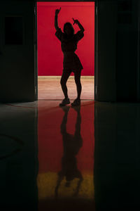Silhouette woman walking on floor