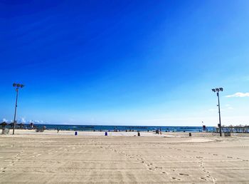 Scenic view of beach against blue sky