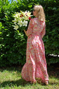 Rear view of woman standing by plants