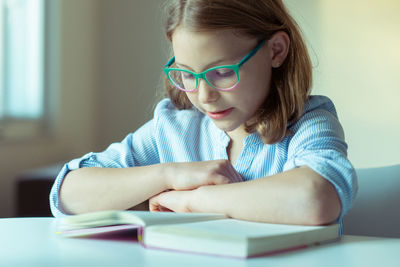 Close-up of girl reading book