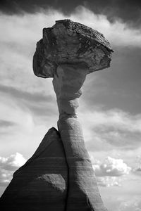 Low angle view of sculpture against cloudy sky
