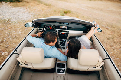 Rear view of people sitting in car