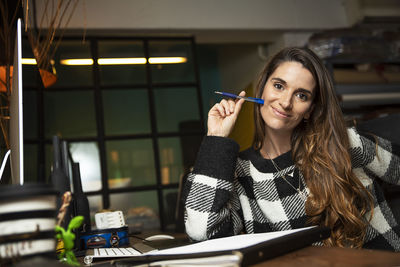 Portrait of smiling businesswoman sitting at office