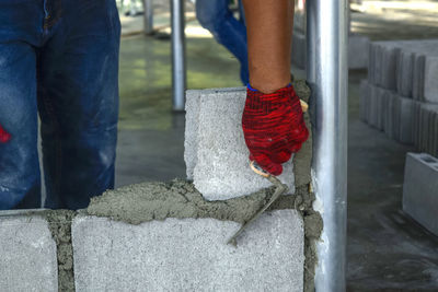 Low section of man working on concrete floor