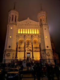 People in illuminated building at night