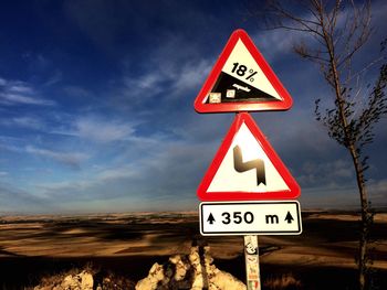 Low angle view of signboard against sky