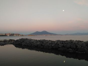 Scenic view of sea against clear sky during sunset