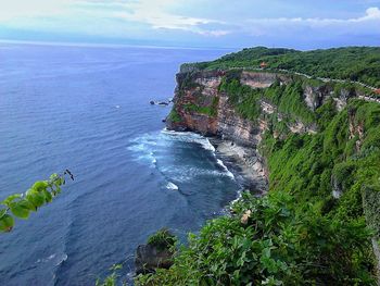 Scenic view of sea and mountains against sky