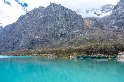 Scenic view of lake and mountains against sky