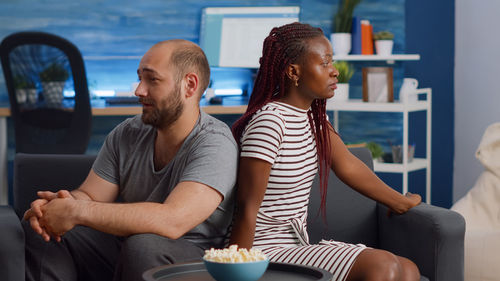 Young couple sitting at home