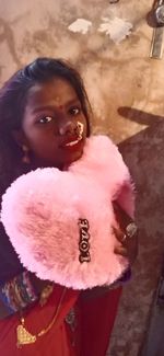 High angle portrait of woman holding heart shape