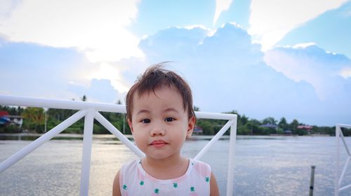 Portrait of cute boy against sky