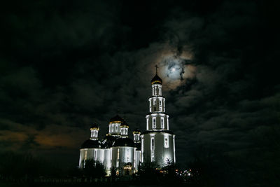 Low angle view of illuminated building against sky at night