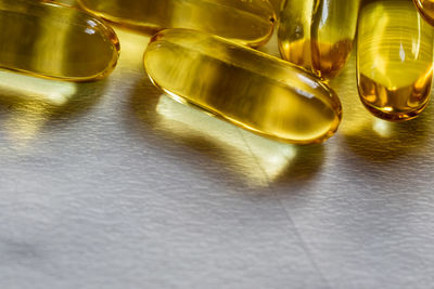 Close-up of cod liver oil capsules on table