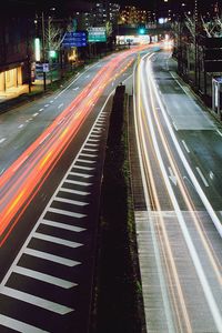 High angle view of light trails on road at night