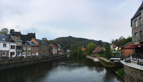 Canal amidst buildings in town against sky