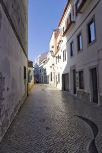 Narrow alley amidst buildings in city