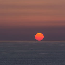 Scenic view of landscape against orange sky