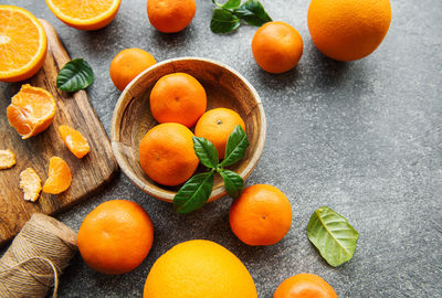 Fresh citrus fruits tangerines, oranges on a concrete background