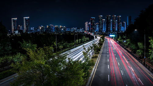 High angle view of illuminated city and road at night