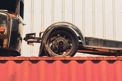 Close-up of old rusty car against metal