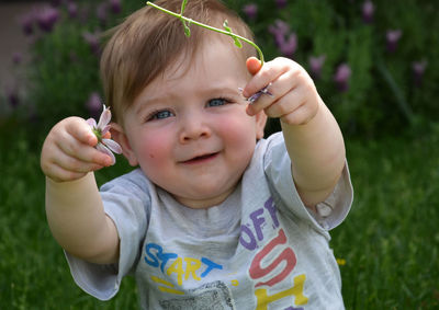 Portrait of cute boy holding flower