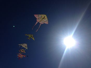 Low angle view of illuminated flag against sky