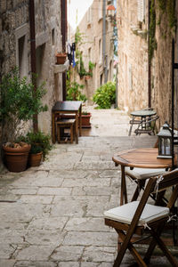 Empty chairs and tables in front of building