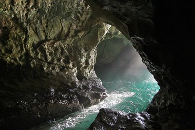 Scenic view of sea seen through cave