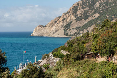 Scenic view of sea and mountains against sky