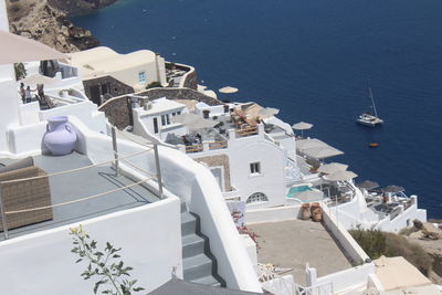 High angle view of buildings by sea in town