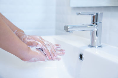 Midsection of woman in bathroom at home