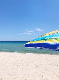 Scenic view of beach against blue sky