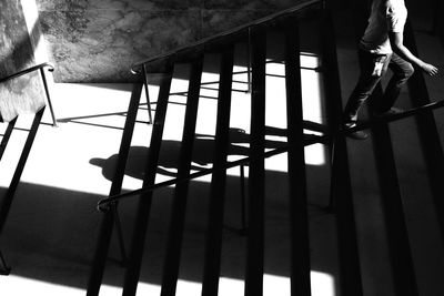 Low section of man standing on railing