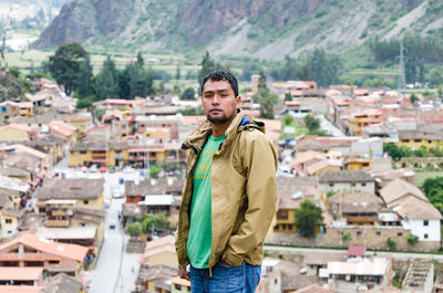 Portrait of young man standing in city