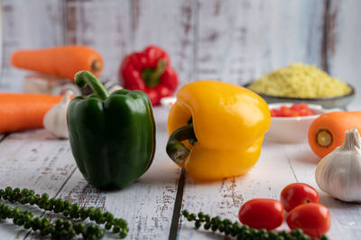 Close-up of multi colored bell peppers on table