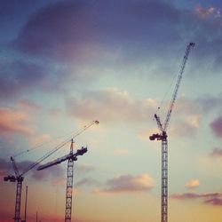 Low angle view of crane against sky