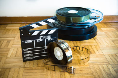 Close-up of film reels and movie slate on floor