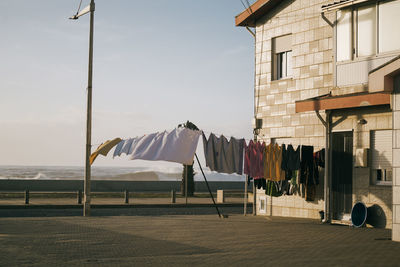 Street clothesline on against blue sky and wavy coast