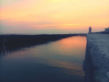 Scenic view of lake against sky during sunset