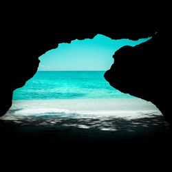 Scenic view of sea seen through cave