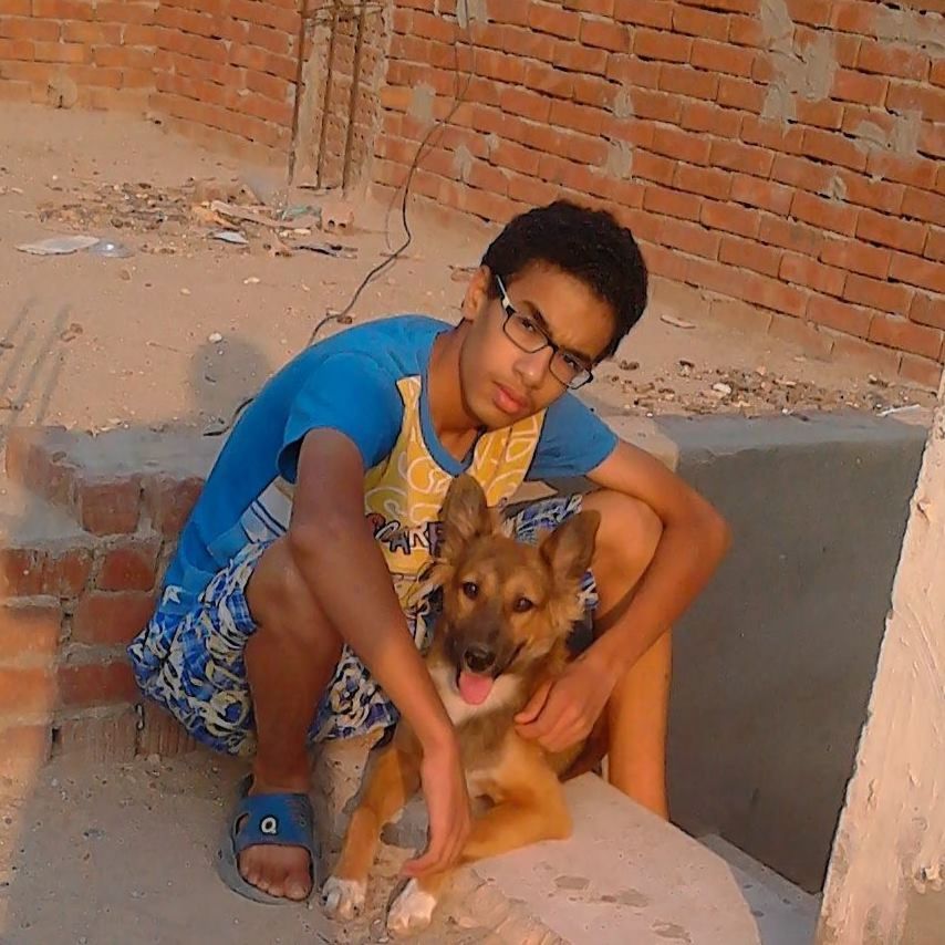 PORTRAIT OF YOUNG WOMAN WITH DOG SITTING ON FLOOR