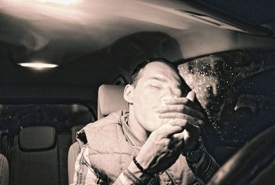 High angle view of woman sitting in car