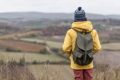 Rear view of man standing on field