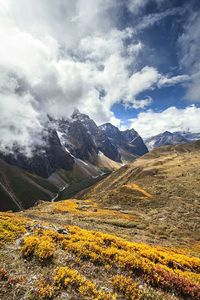 Scenic view of mountains against cloudy sky