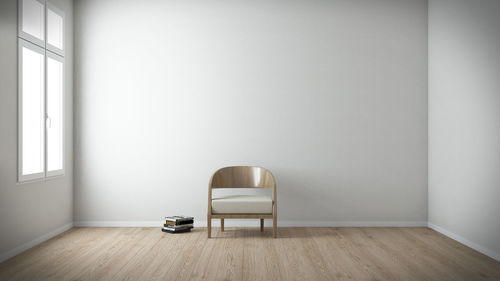 Empty chair against wall at home