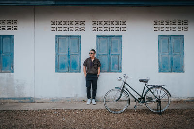 Full length of young man standing by window