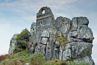 Low angle view of rock formation against sky